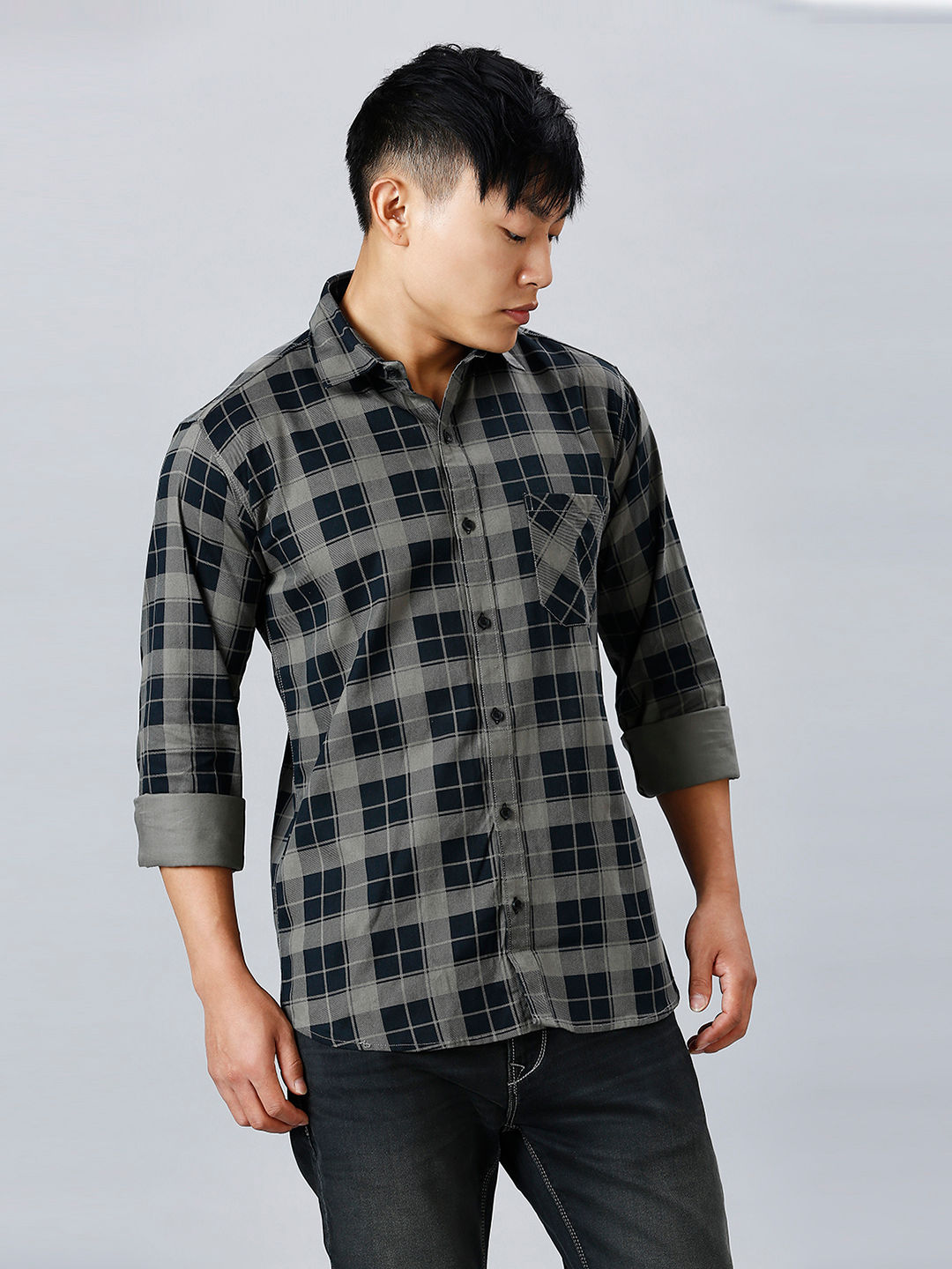 a man in a black and grey checkered shirt