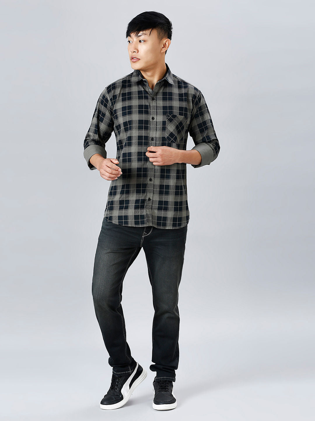 a young man in a black and grey checkered shirt