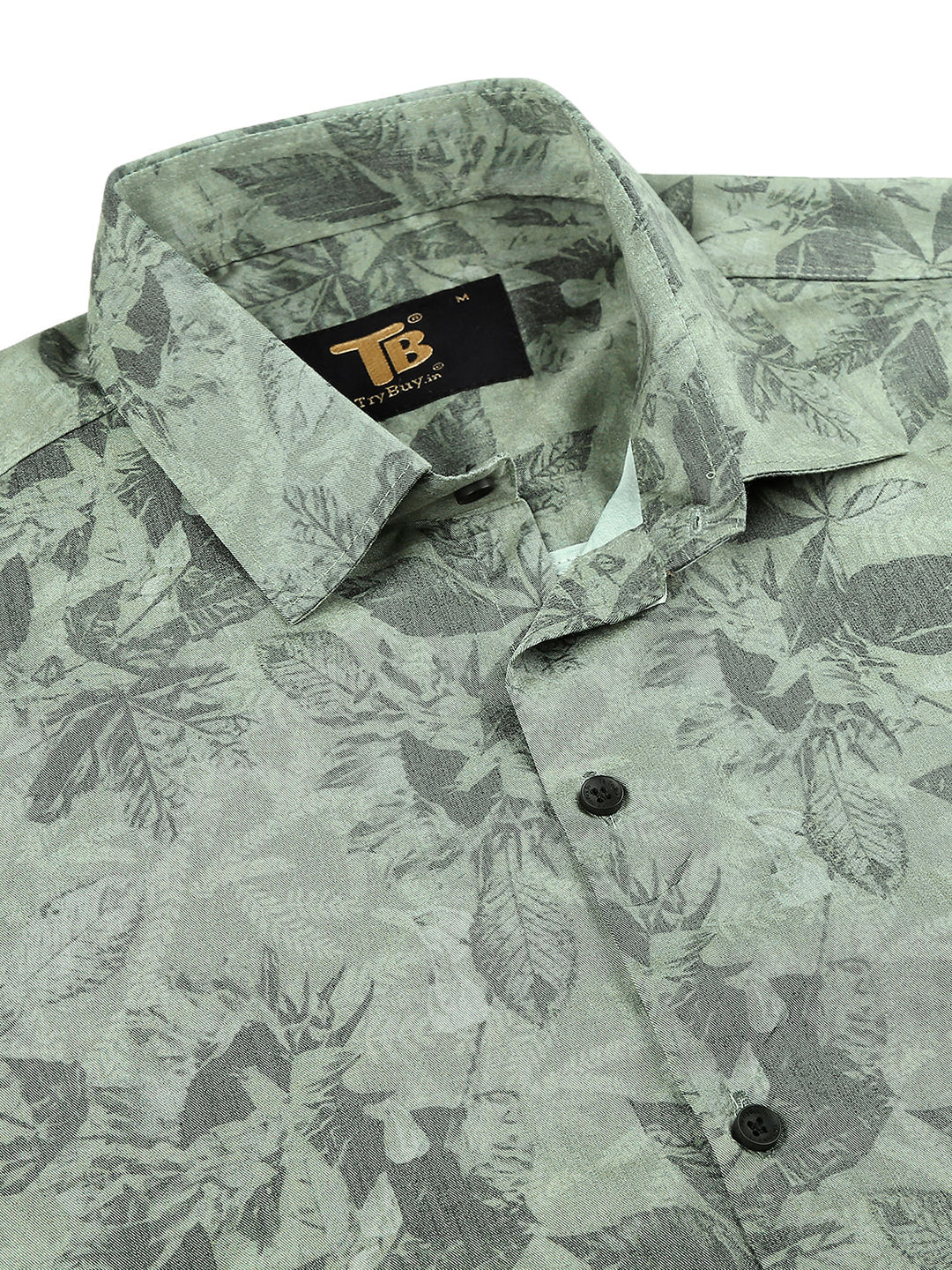 a close up of a shirt with leaves on it