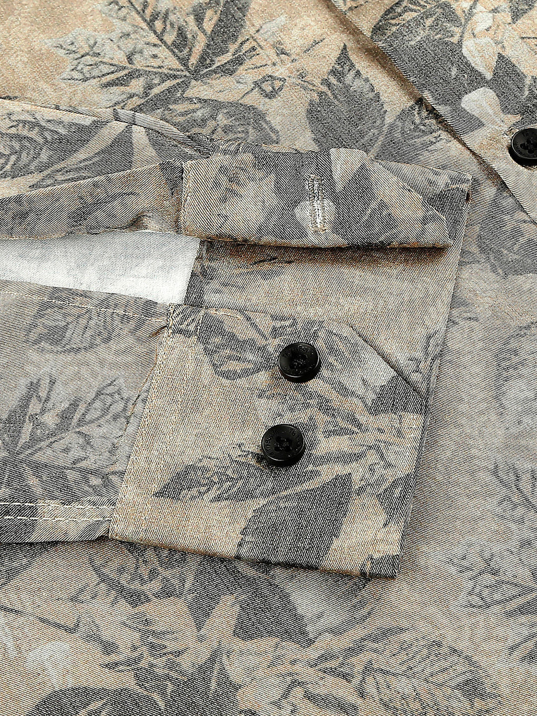 a close up of a shirt with a flower pattern