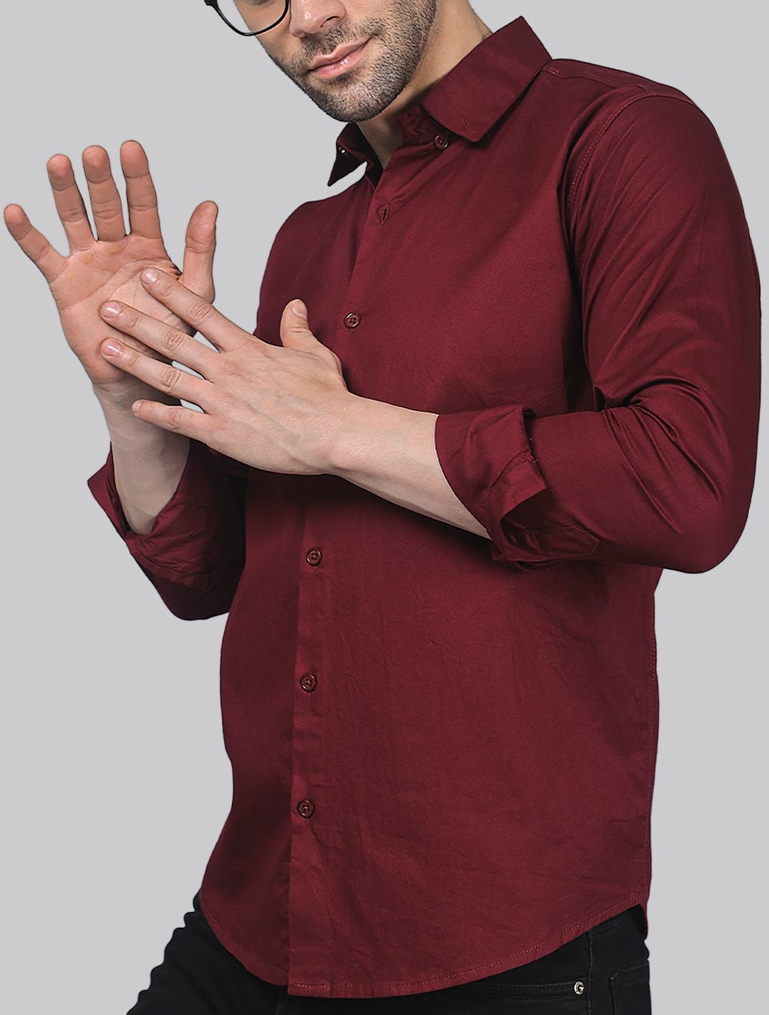 a man in a red shirt is holding his hands together