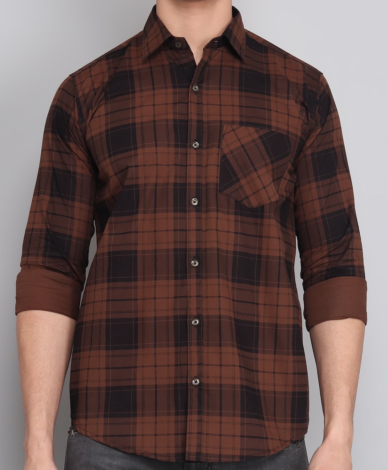 a man wearing a brown and black plaid shirt