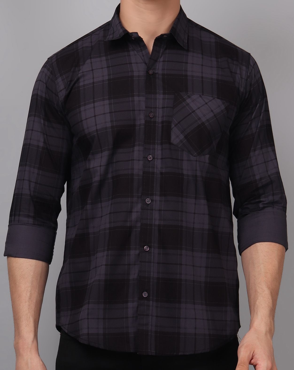 a man wearing a black and grey plaid shirt