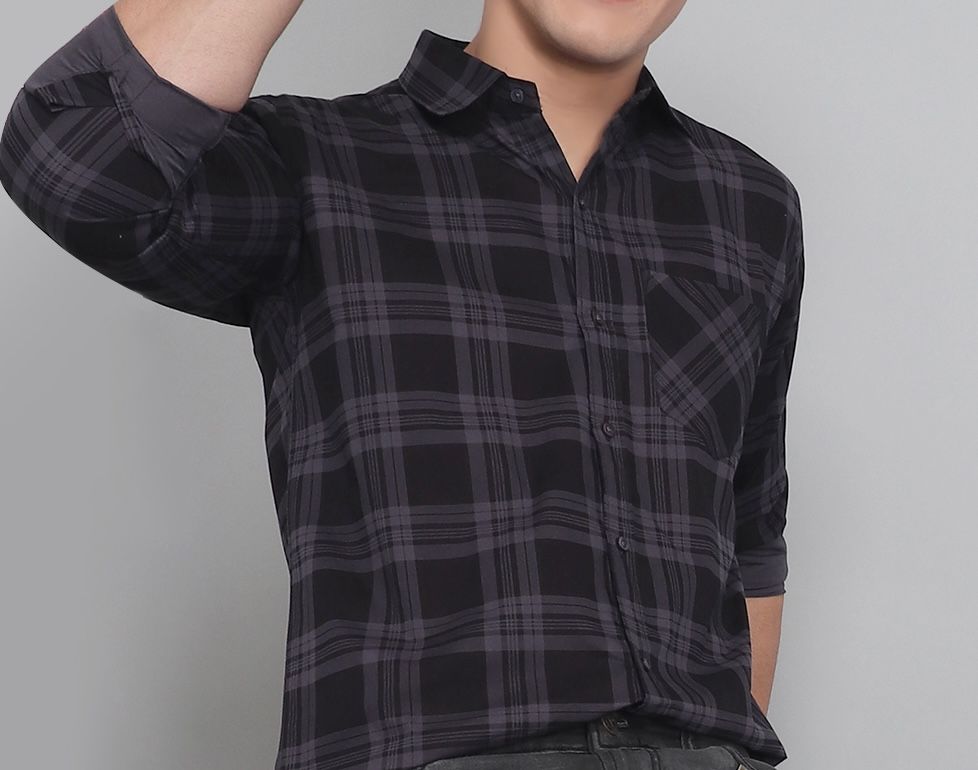 a man in a black and grey plaid shirt