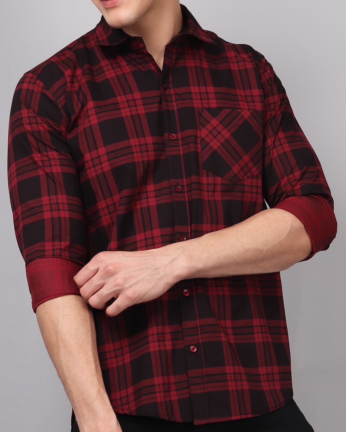 a man wearing a red and black plaid shirt