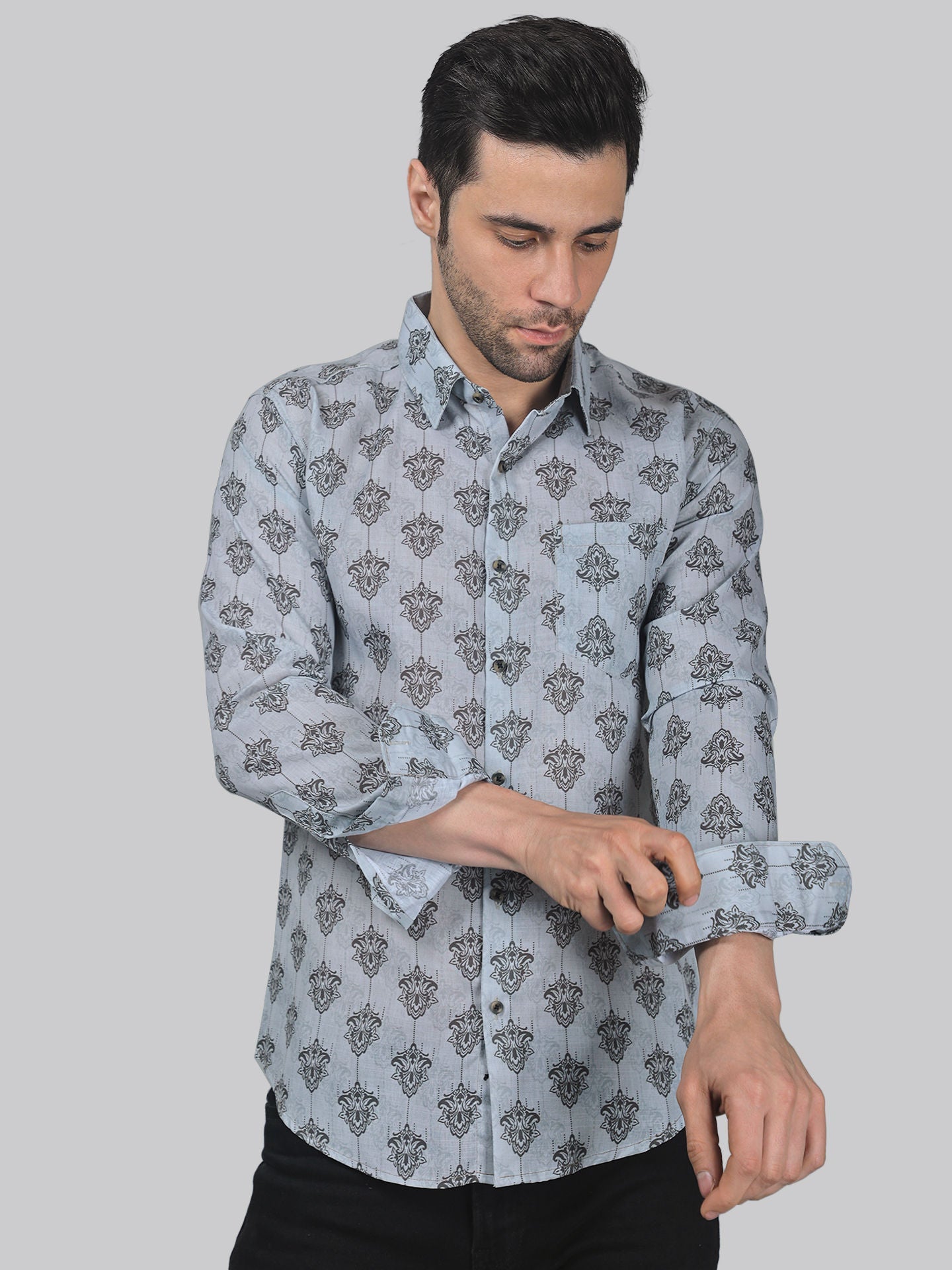 a man wearing a blue shirt with a pattern on it