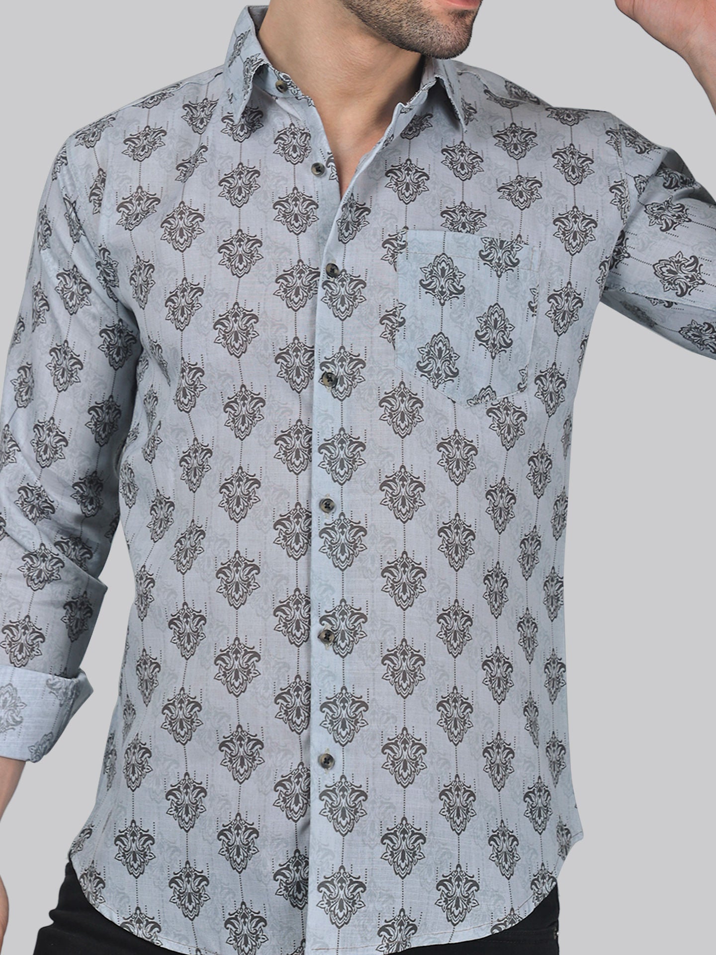 a man wearing a shirt with a flower pattern