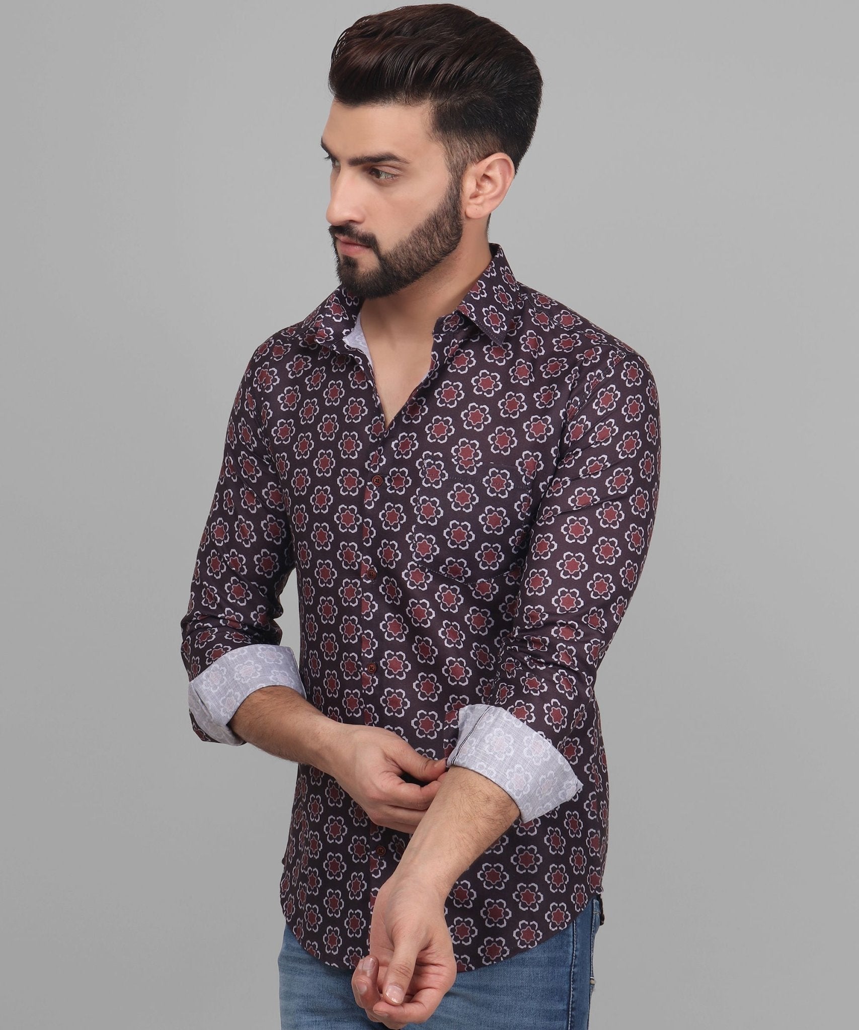 a man with a beard wearing a patterned shirt