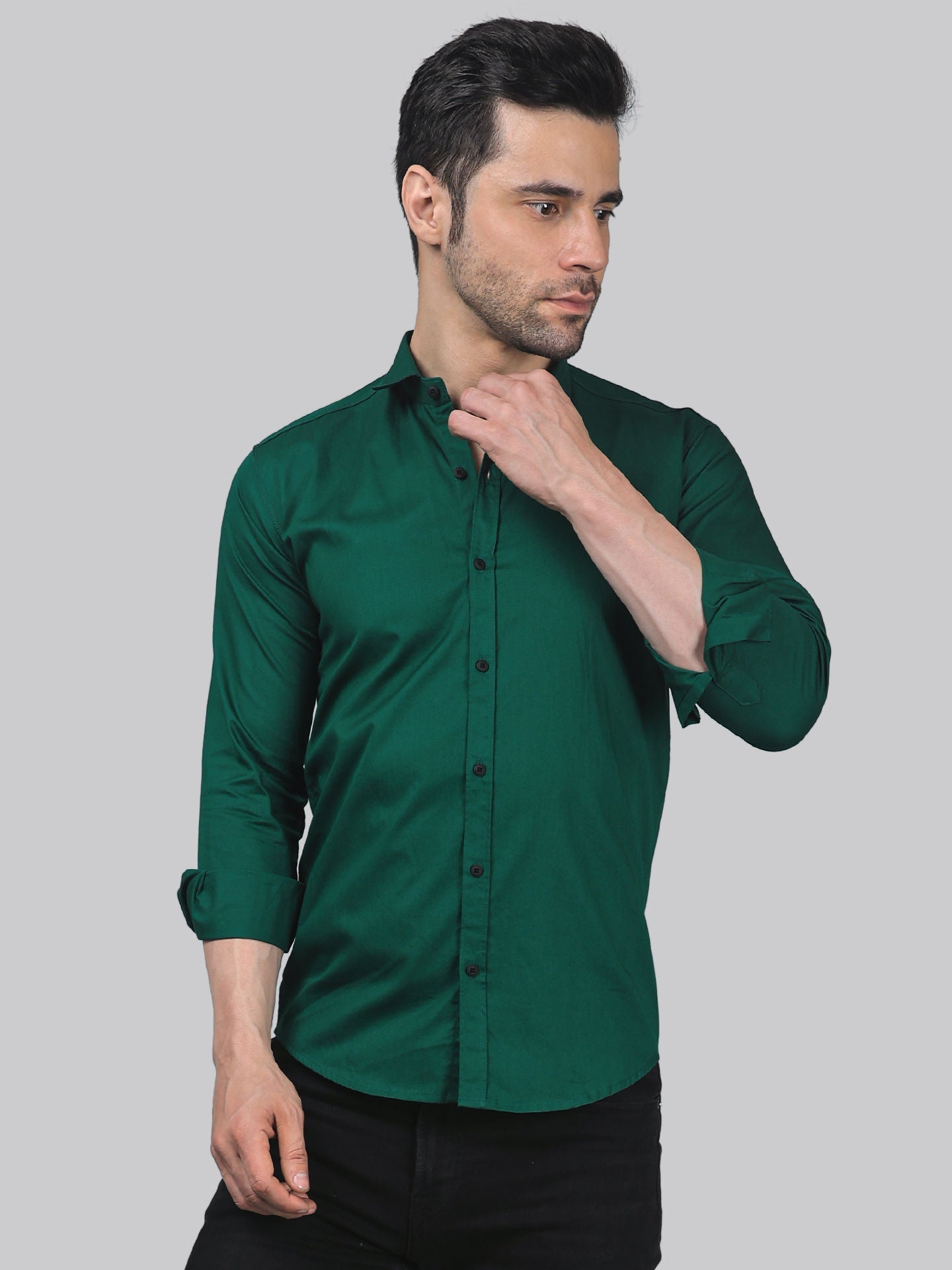 a man wearing a green shirt and black pants