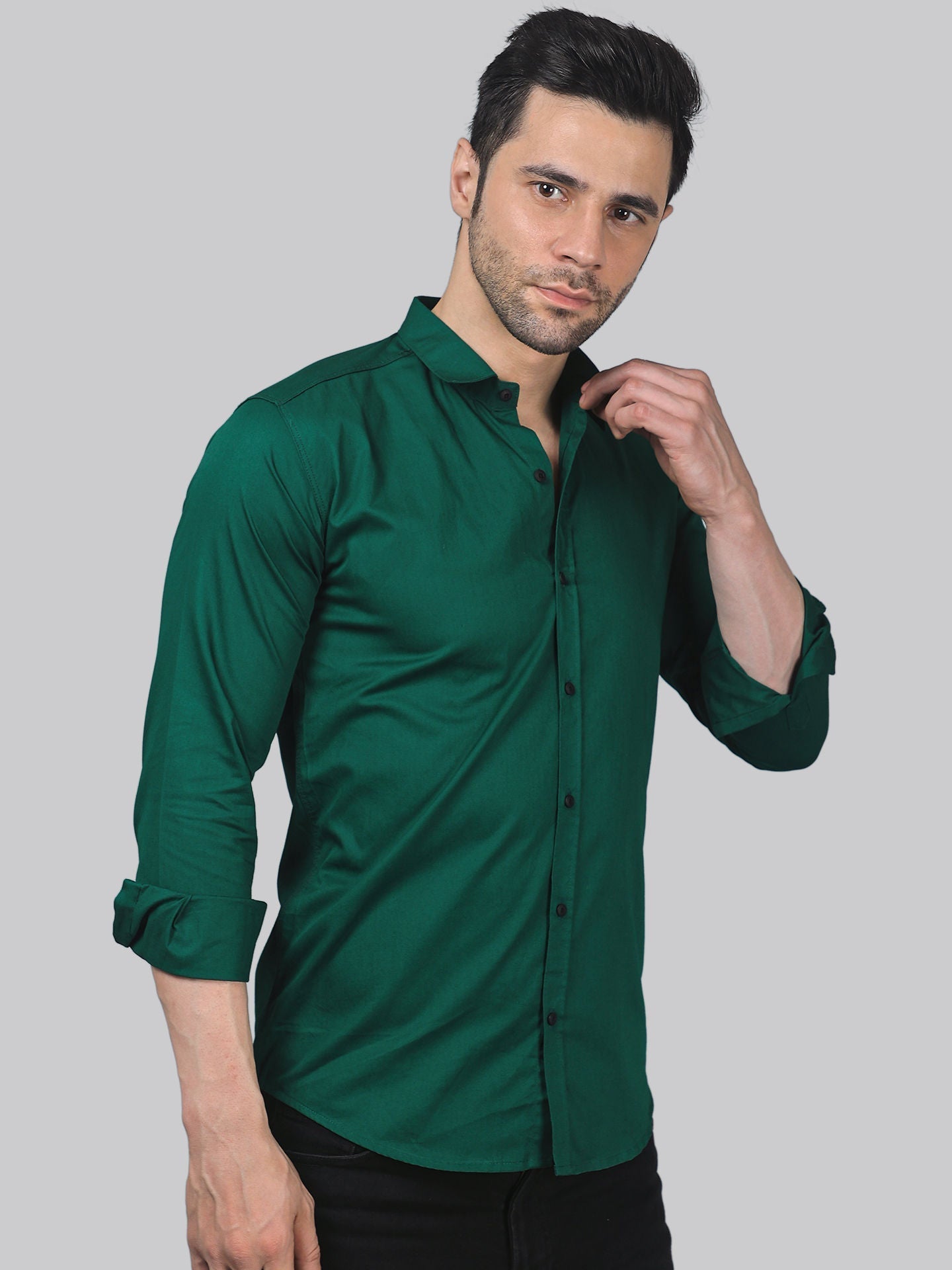 a man wearing a green shirt and black pants