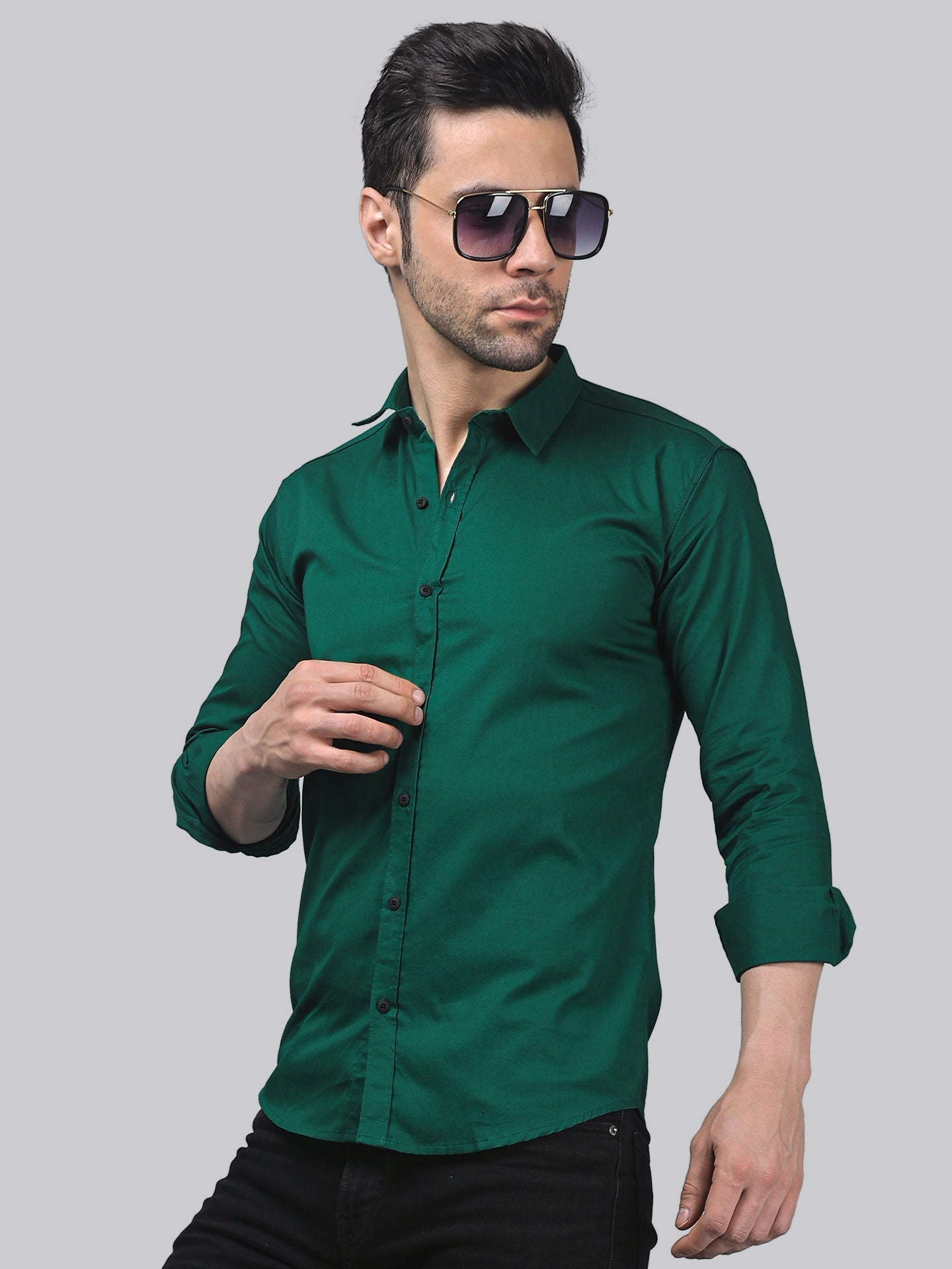 a man wearing a green shirt and sunglasses