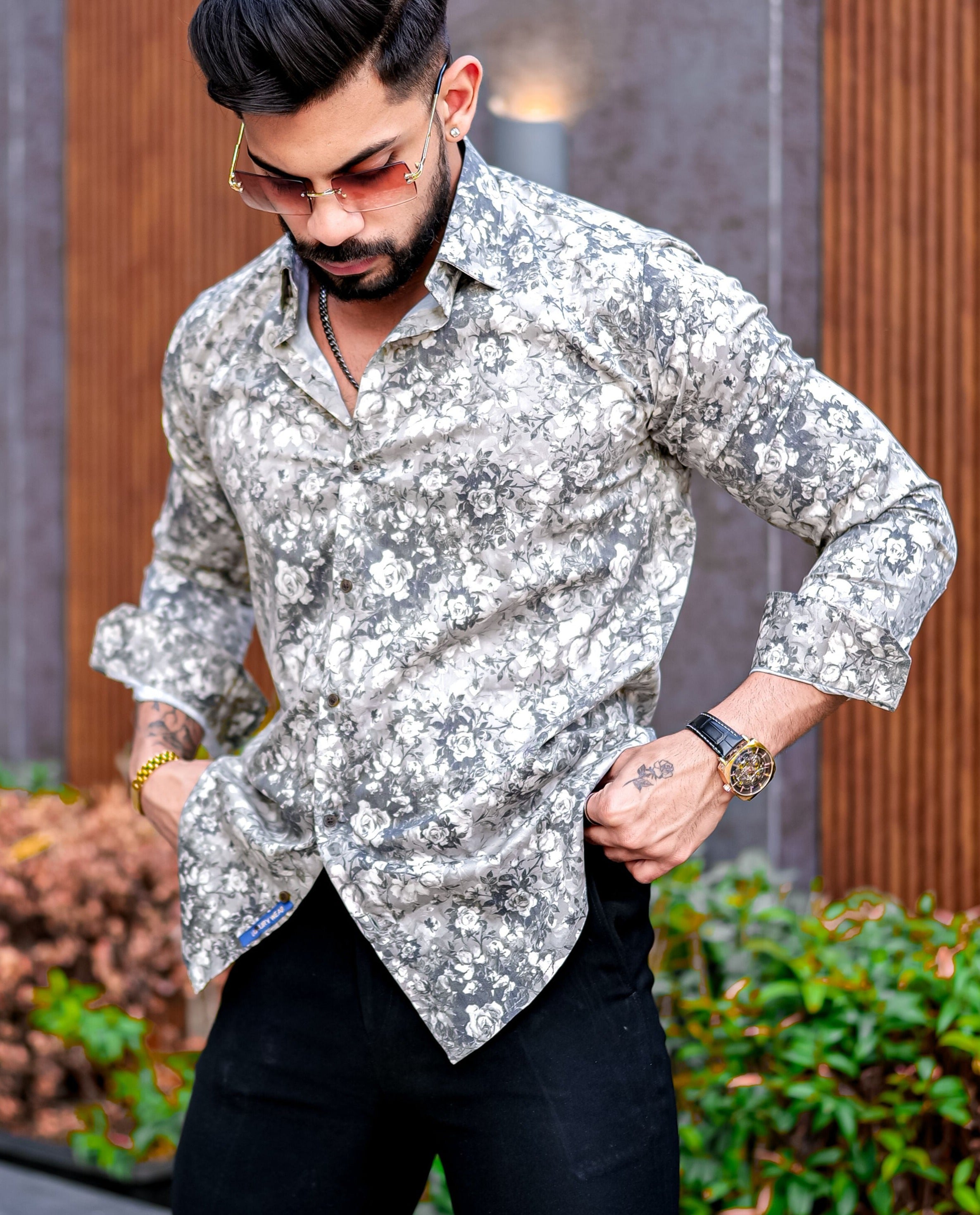 a man with a beard wearing a floral shirt