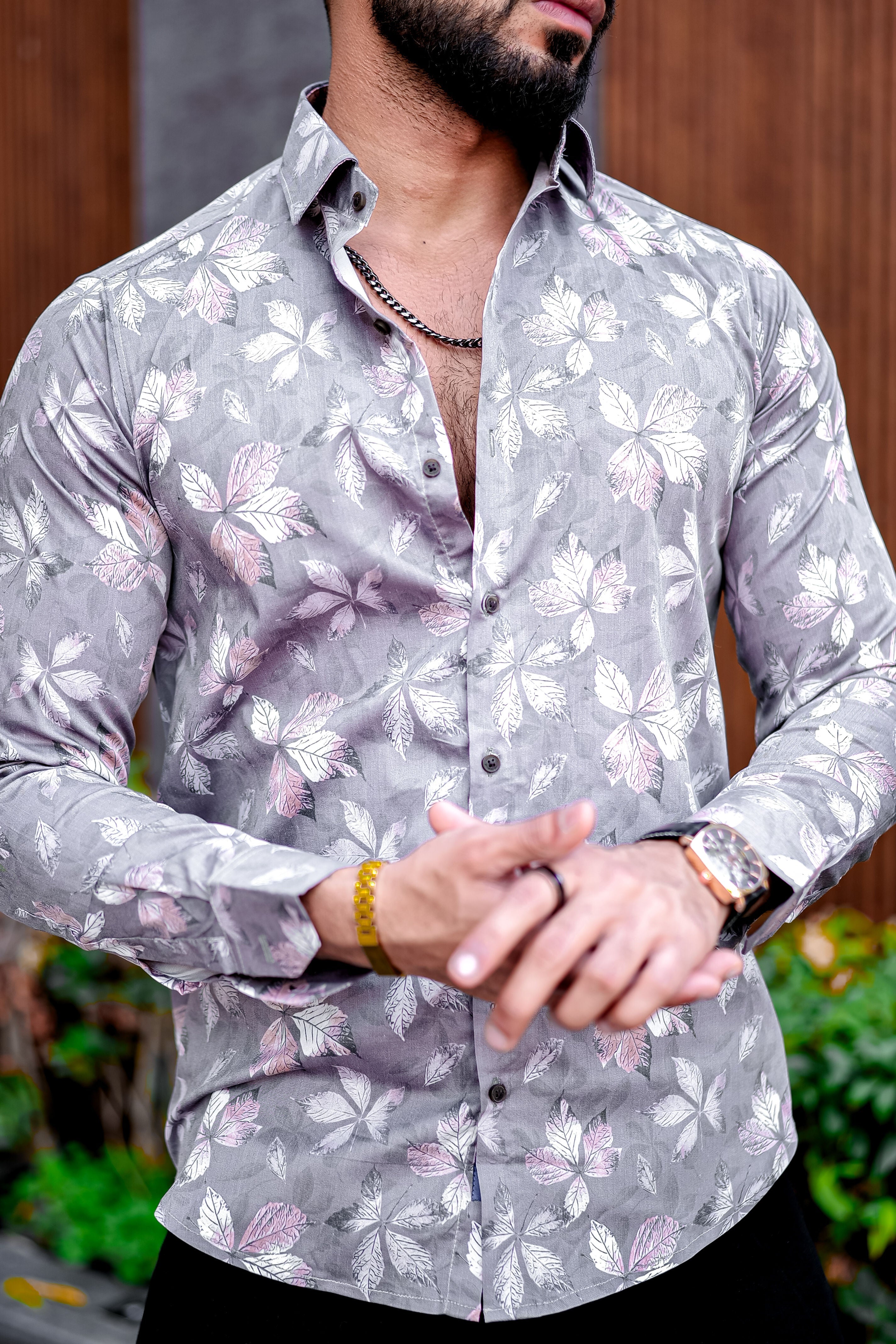 a man wearing a shirt with a flower pattern