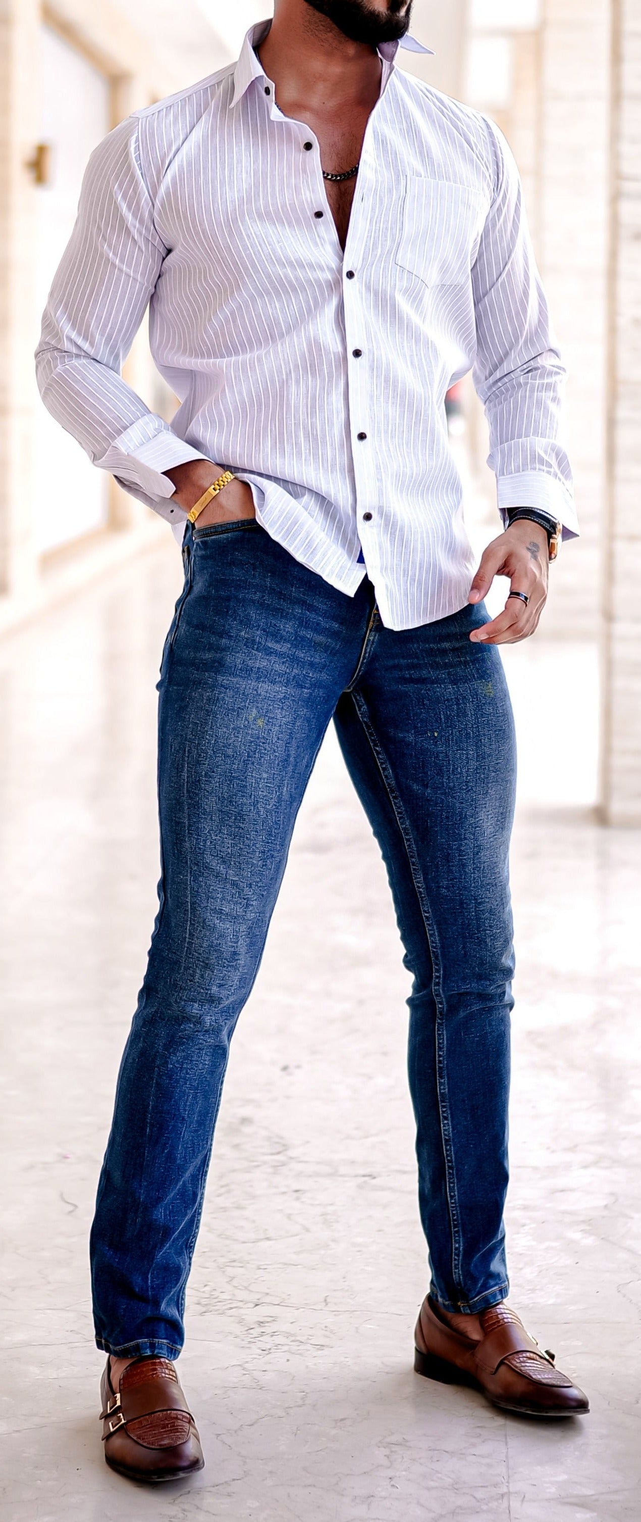 a man in a Check shirt leaning against a wall