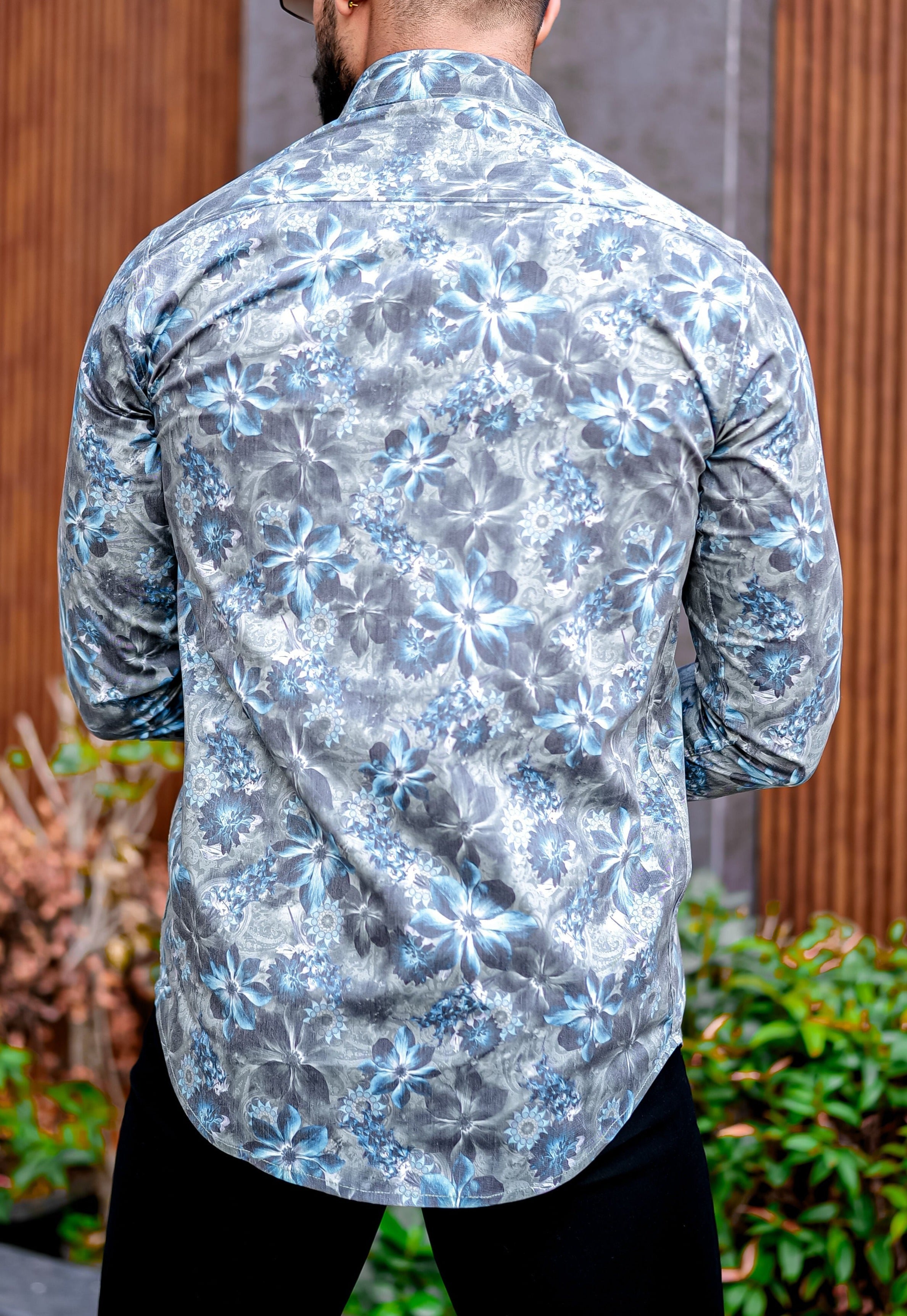 a man with a beard wearing a floral shirt