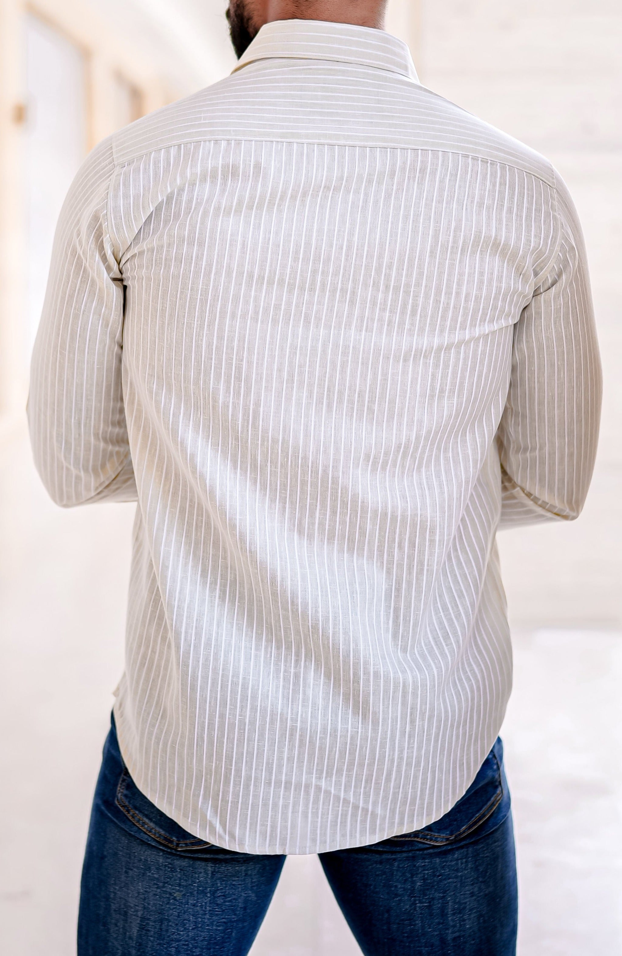 a man standing in a hallway with his back to the camera