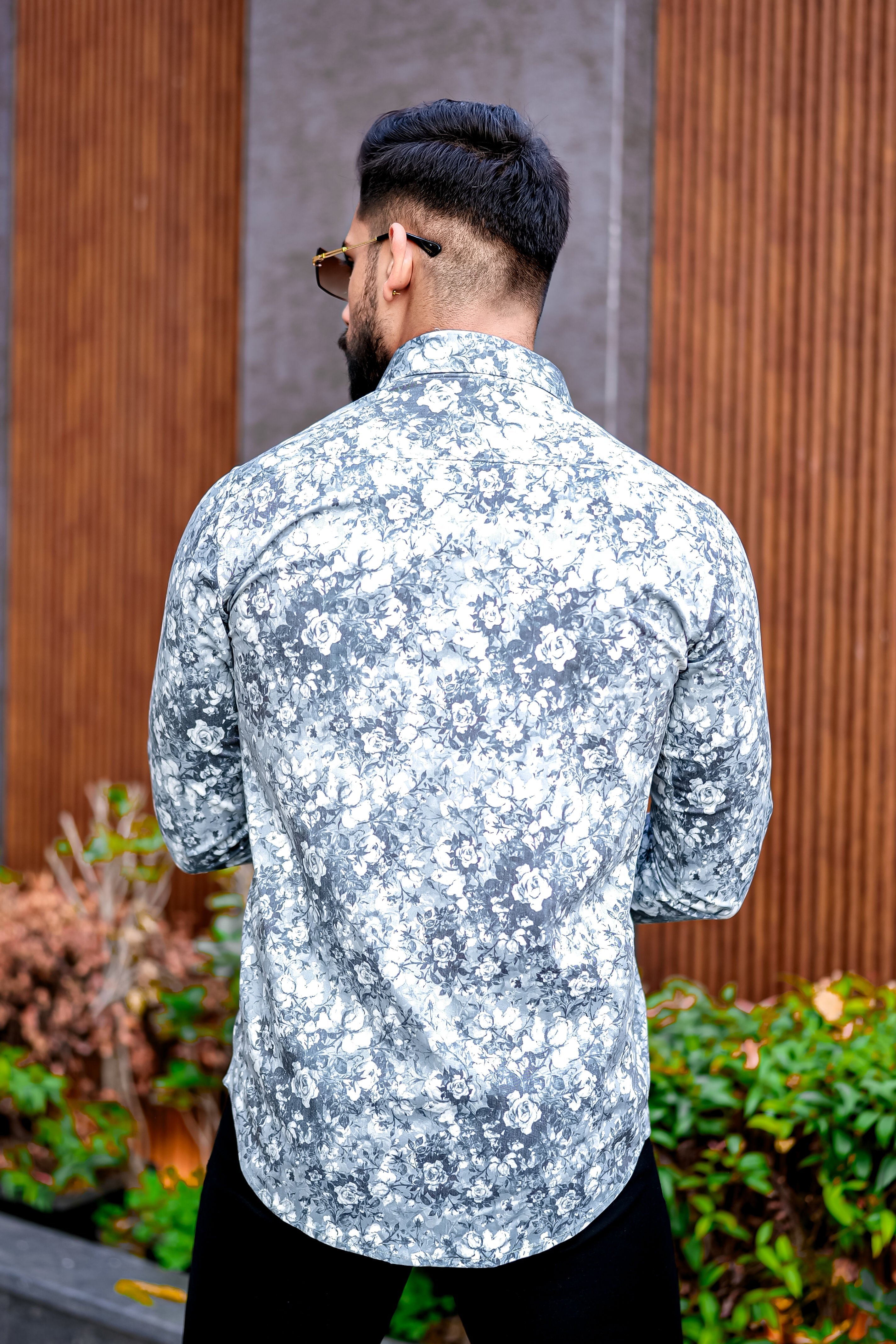 a man with a beard wearing a floral shirt