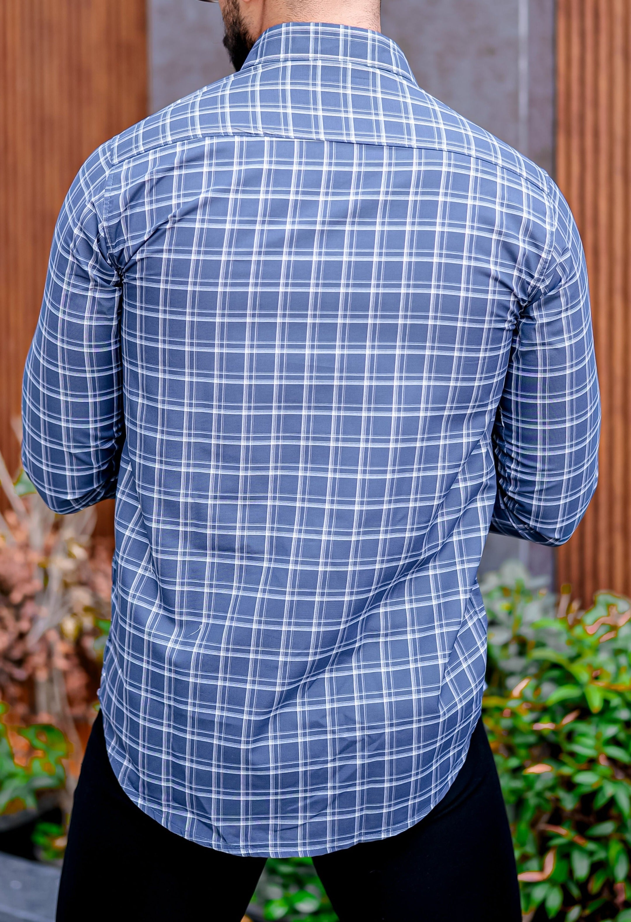 a man in a blue and white checkered shirt