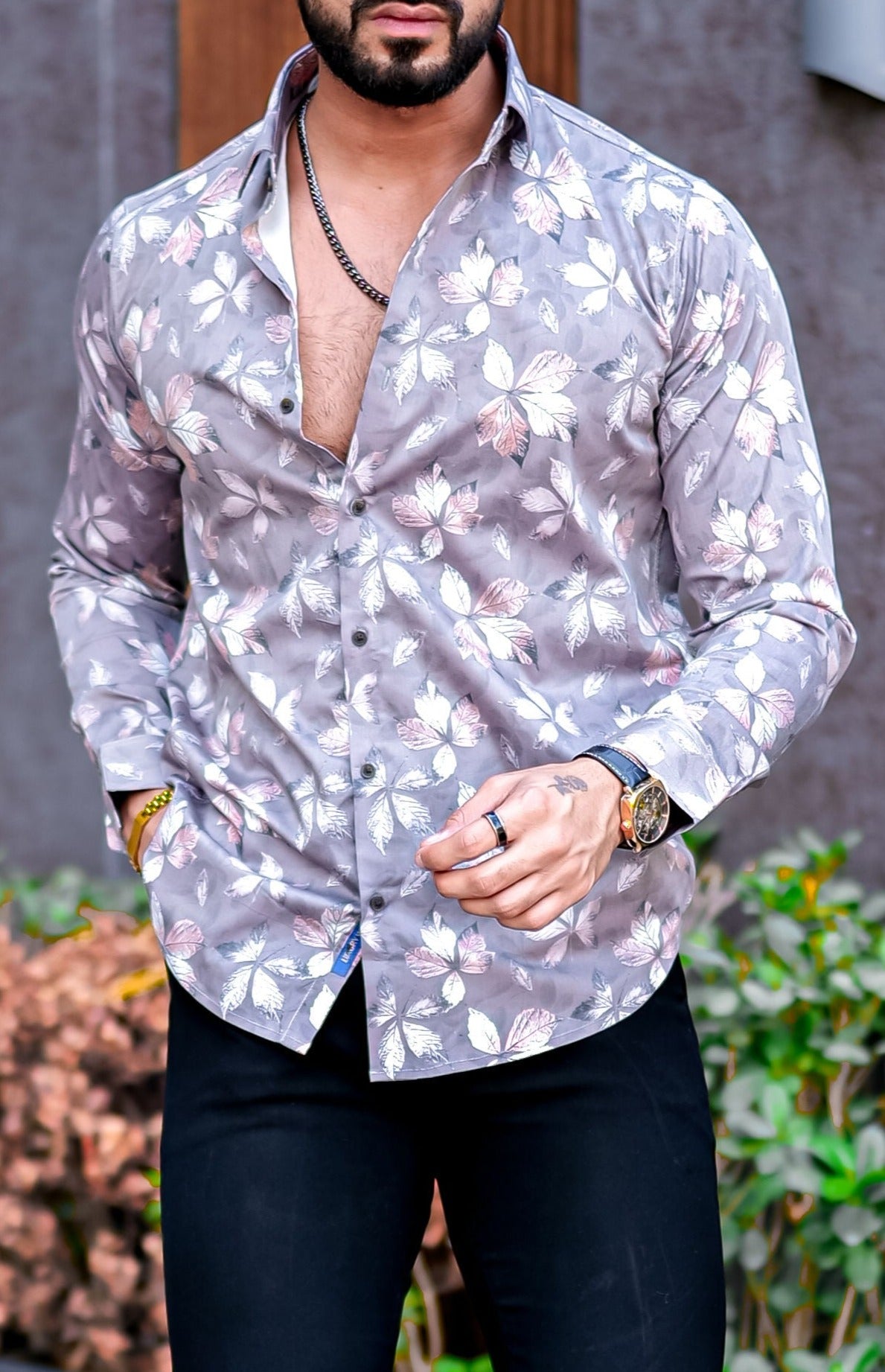 a man wearing a shirt with a flower pattern