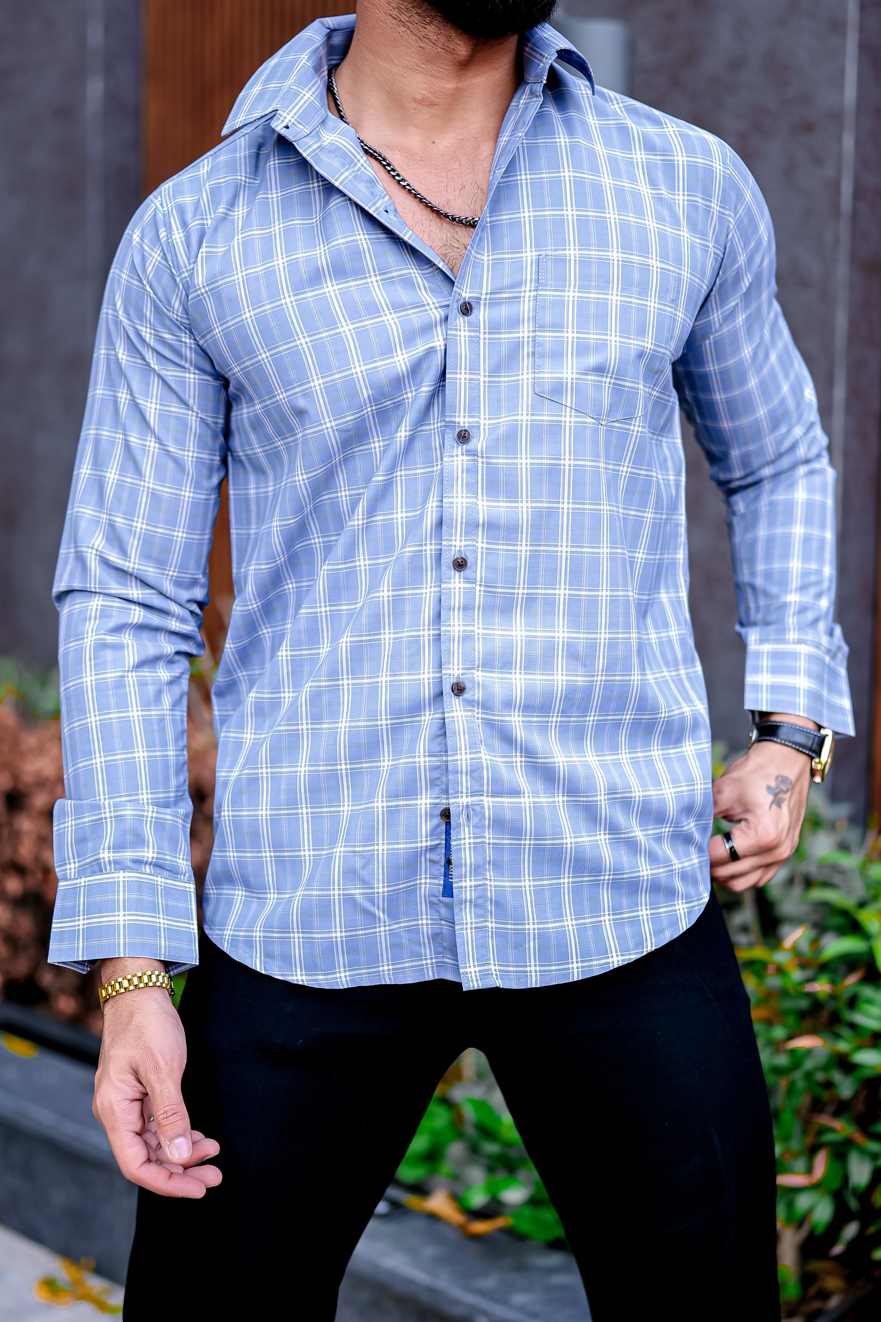 a man with a beard wearing a blue shirt