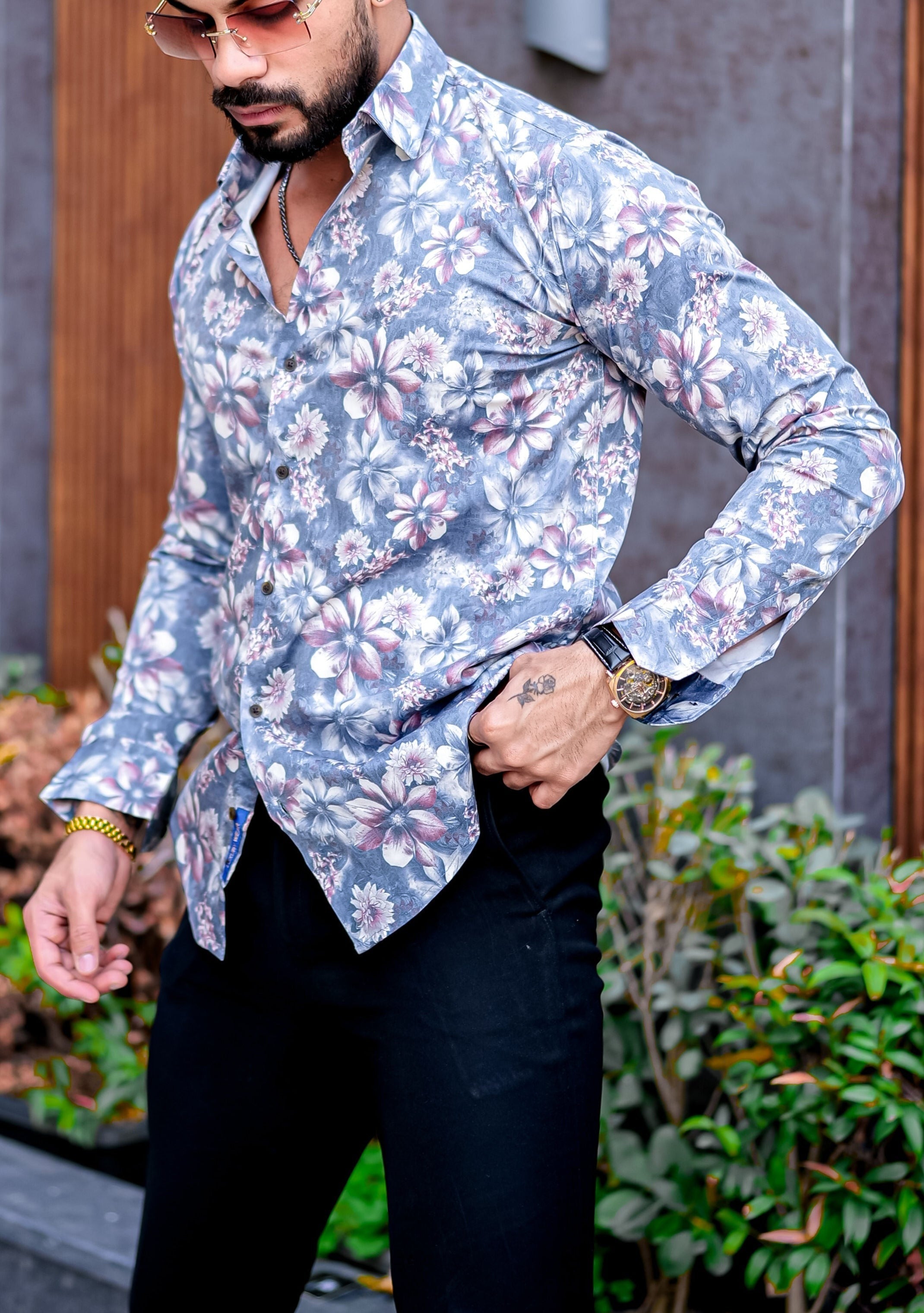 a man in a floral shirt and sunglasses