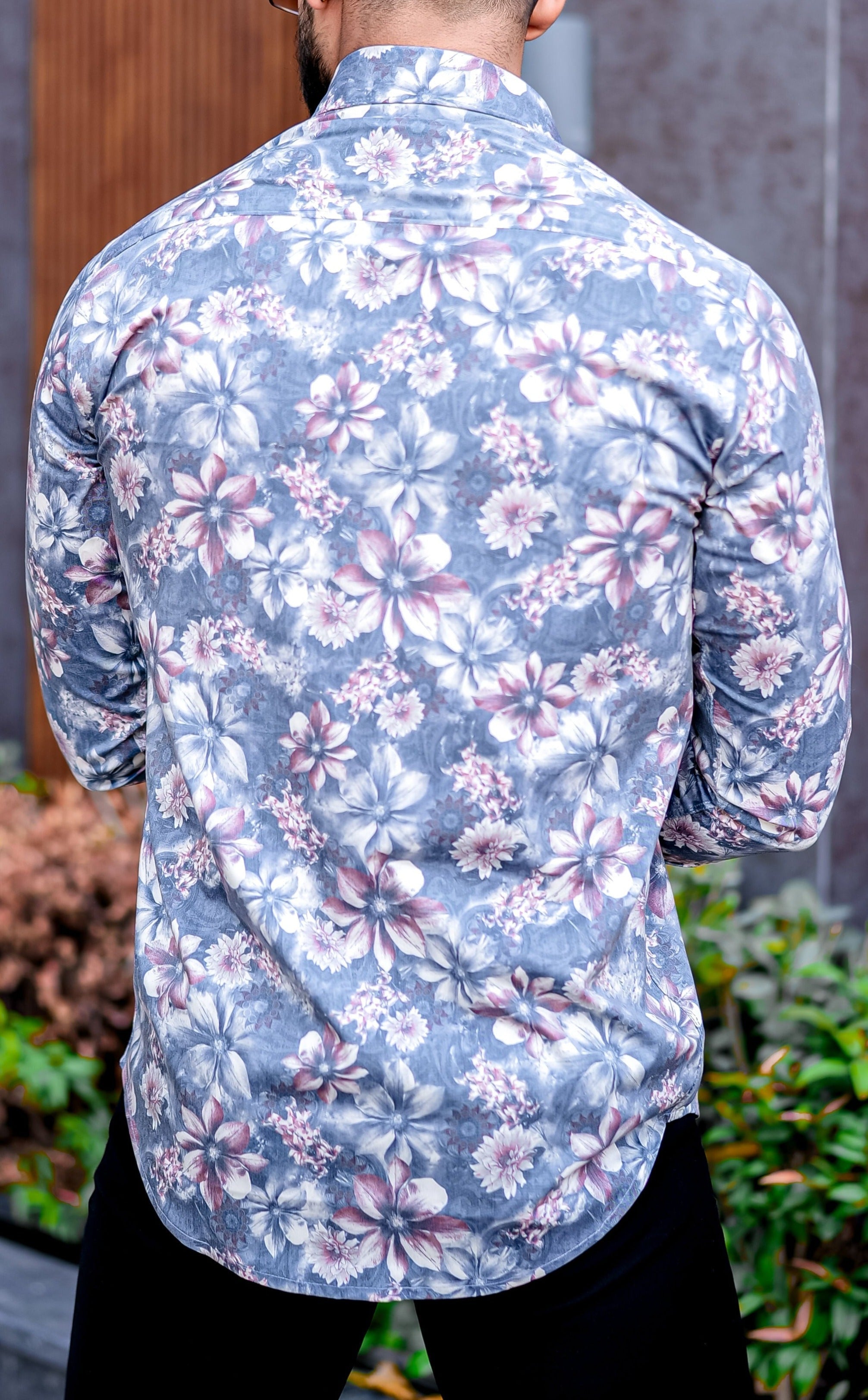 a man with a beard wearing a floral shirt