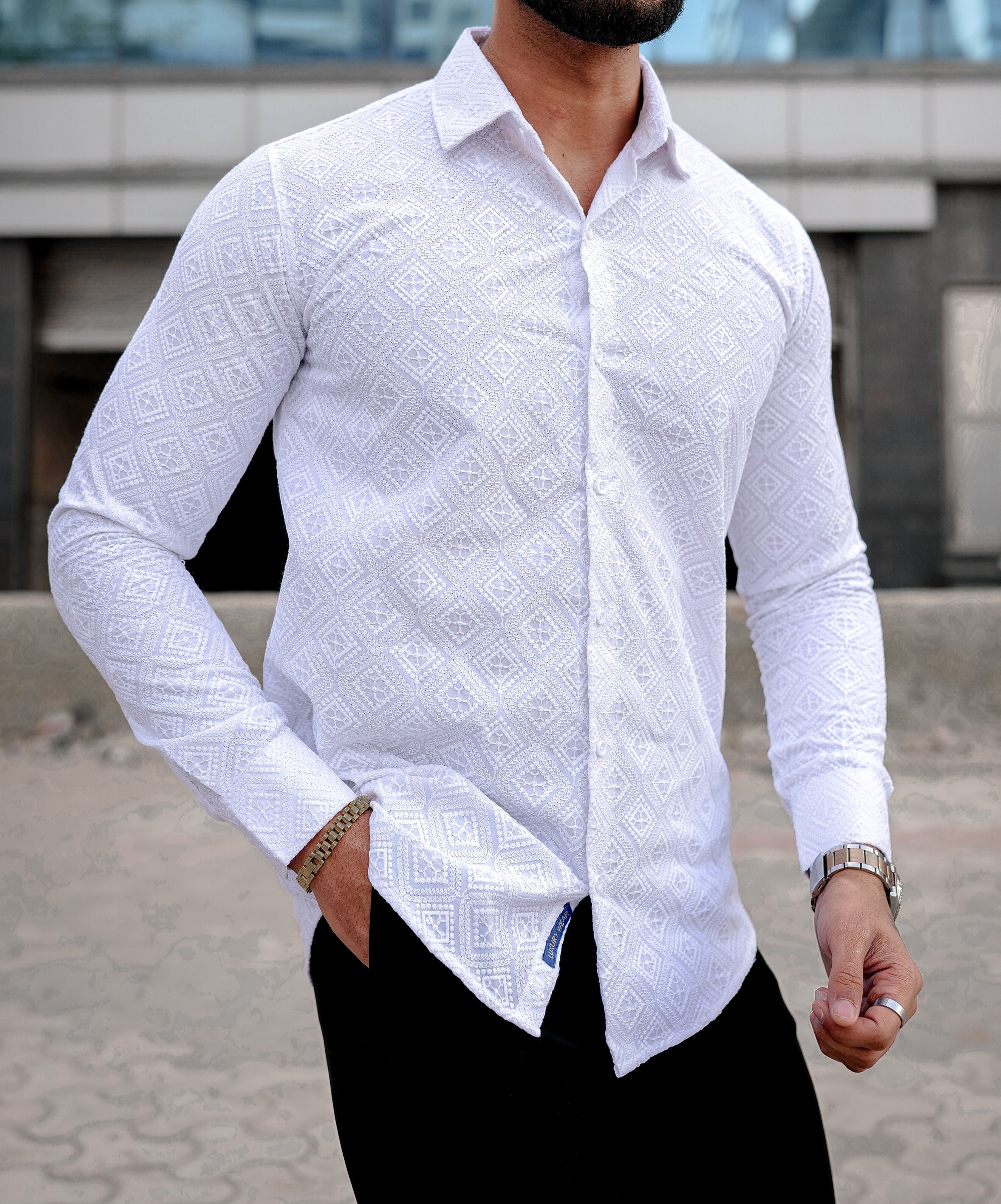 a man wearing a white shirt and black pants