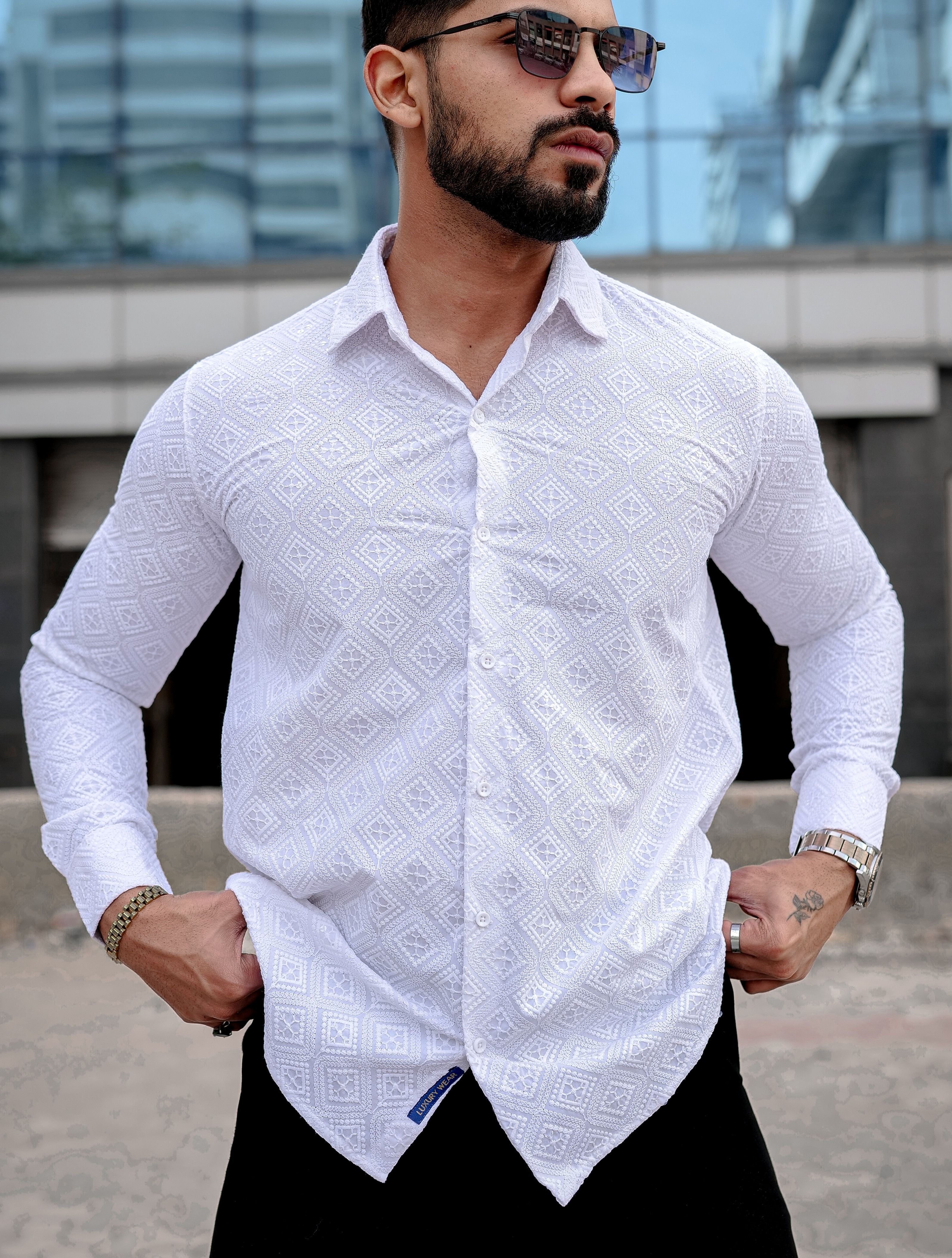 a man wearing a white shirt and black pants