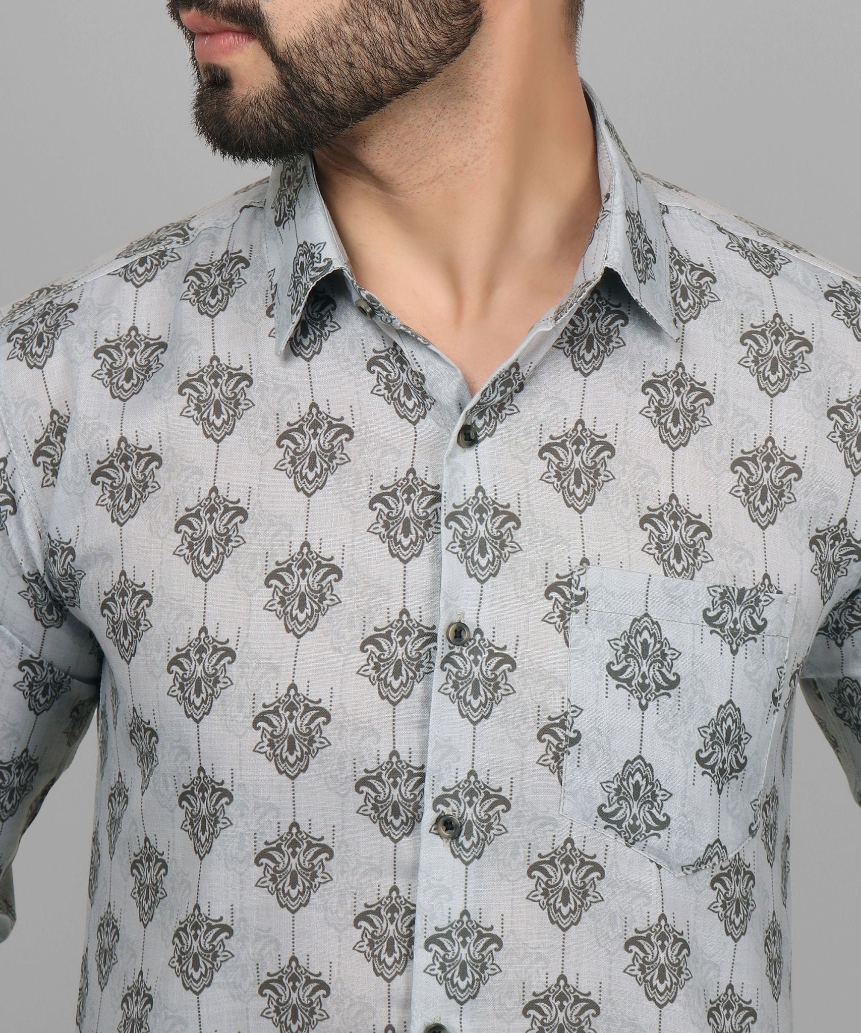 a man with a beard wearing a patterned shirt