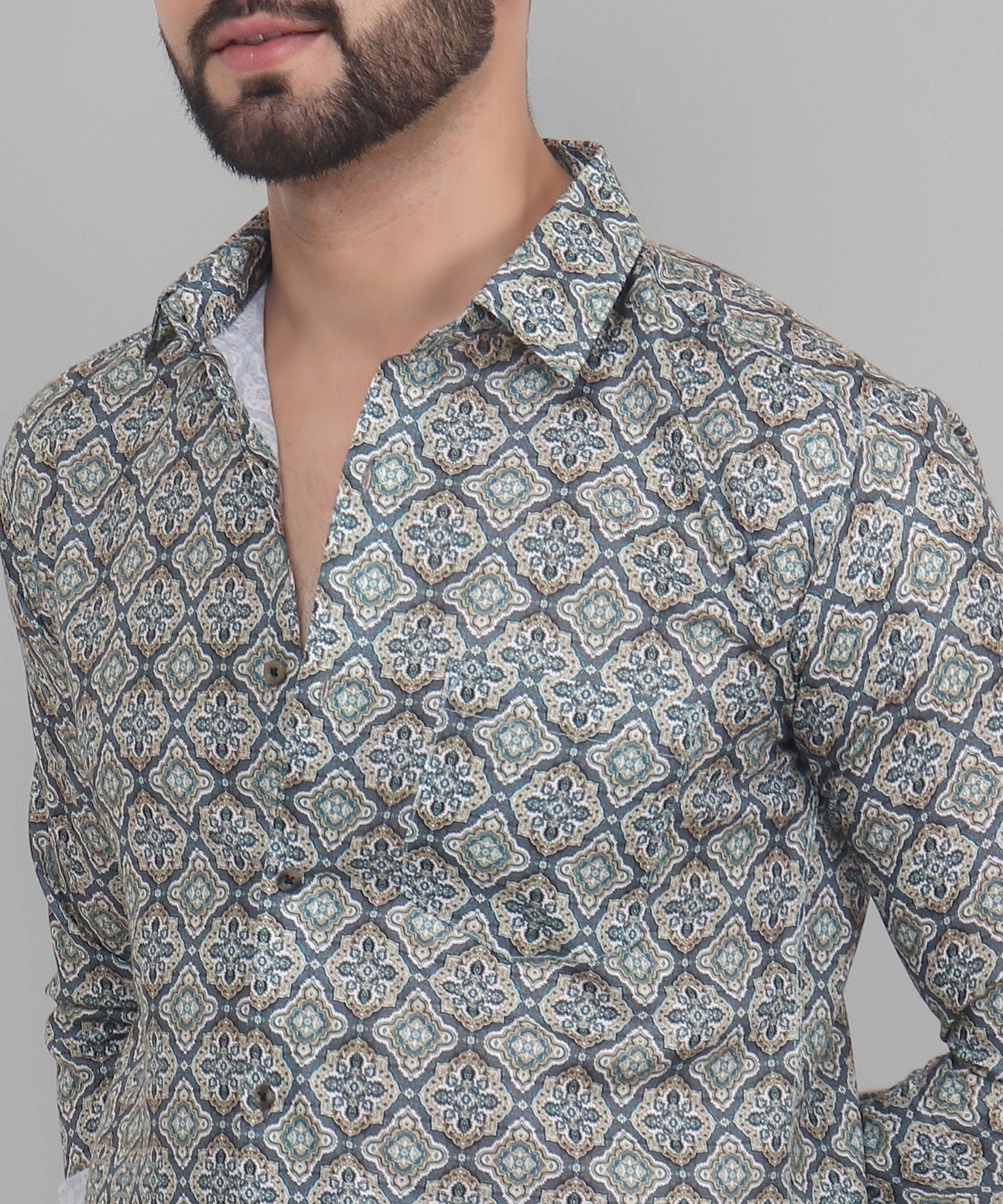 a man with a beard wearing a patterned shirt