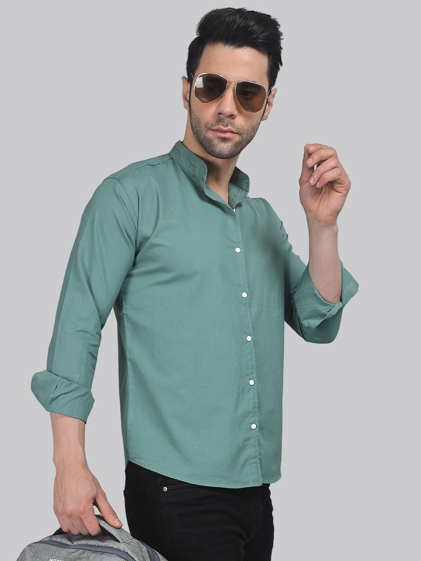 a man in a green shirt is holding a bag