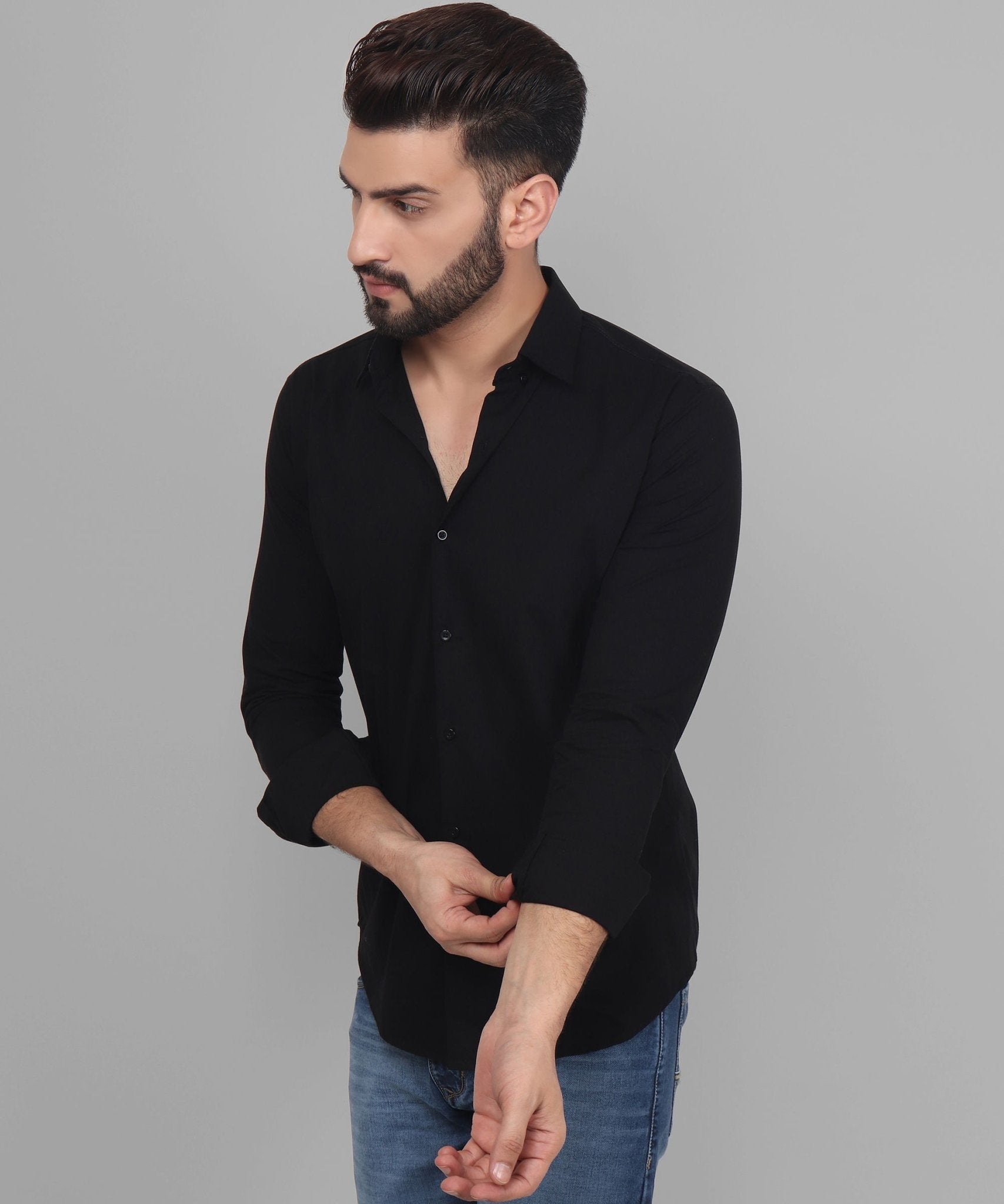 a man wearing a black shirt and jeans