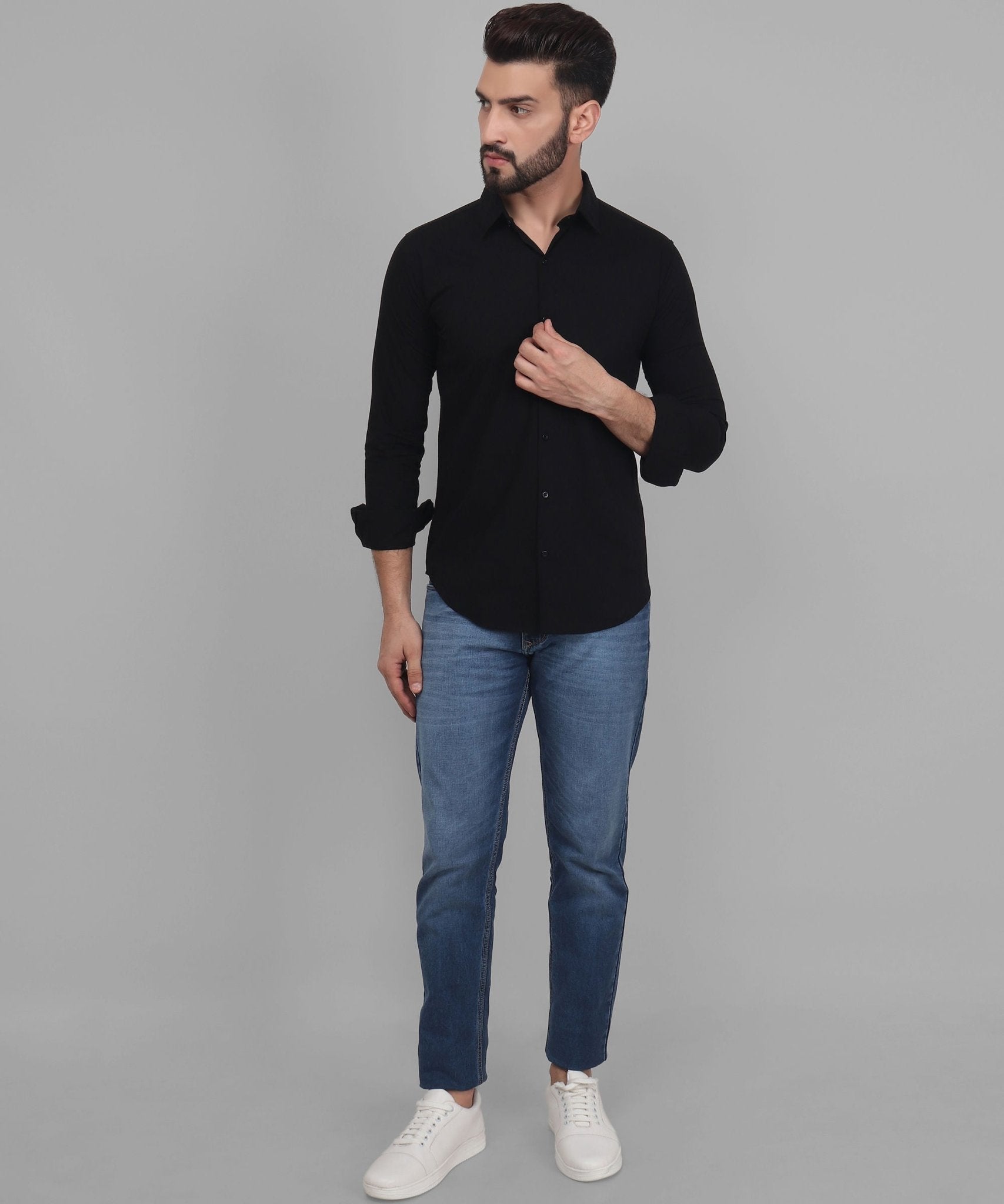 a man wearing a black shirt and jeans