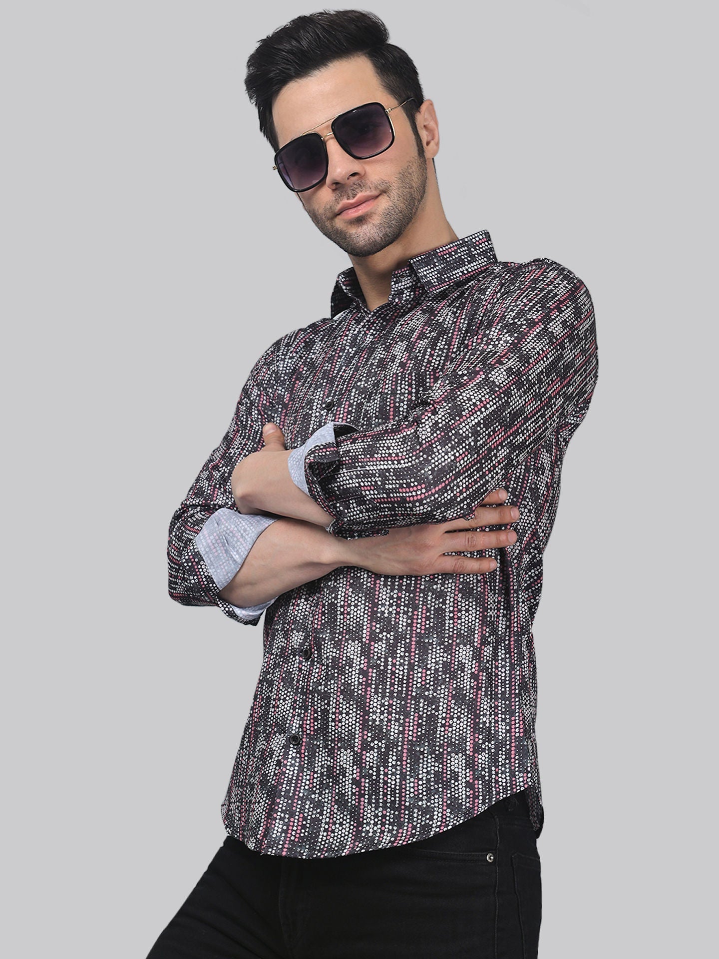 a man in a shirt and sunglasses posing for a picture