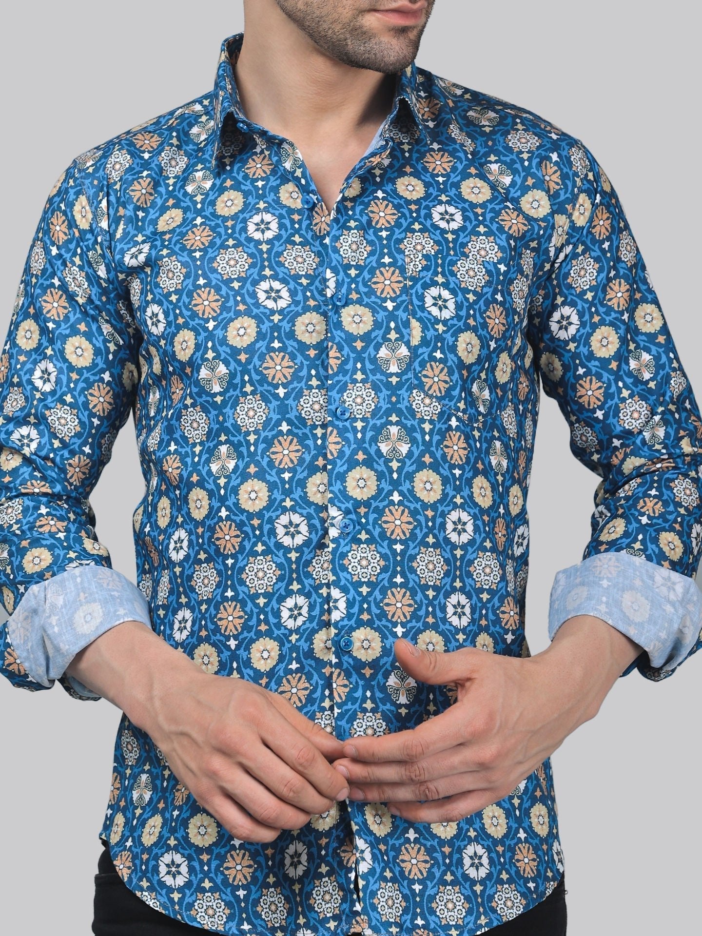 a man wearing a blue shirt with a flower pattern