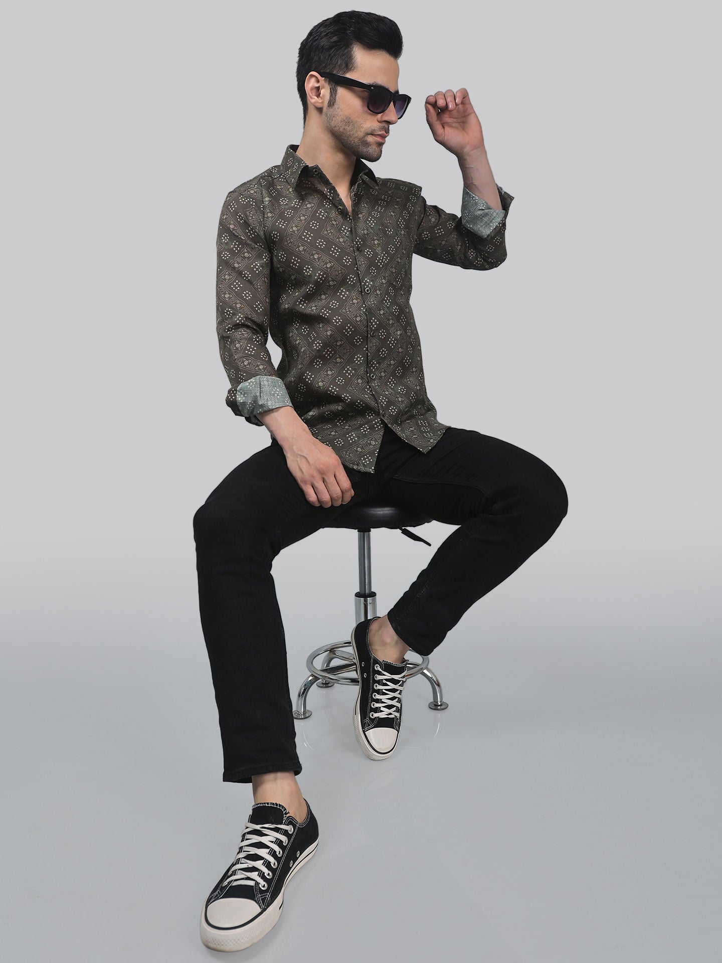 a man sitting on top of a stool